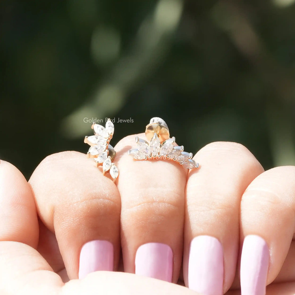 Front view of marquise cut moissanite stud earrings in  yellow gold