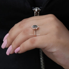 [In finger side view of oval cut halo engagement ring crafted with round cut side stones]-[Golden Bird Jewels]