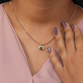 [In neck front view of green emerald cut moissanite pendant set in bezel setting]-[Golden Bird Jewels]