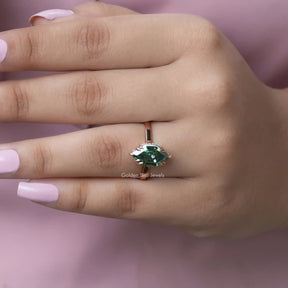 [In hand front view of green marquise cut solitaire ring in 14k yellow gold]-[Golden Bird Jewels]