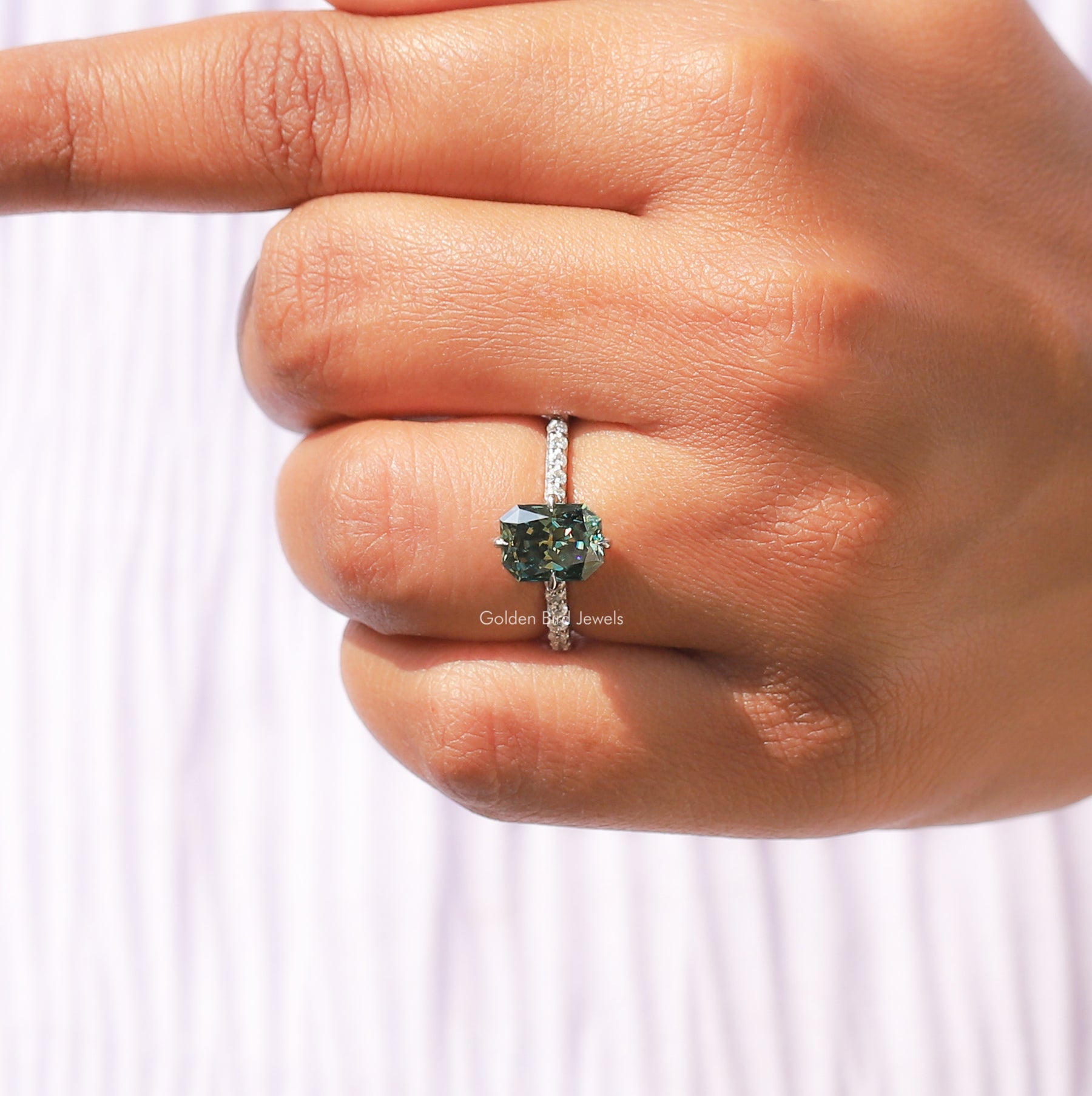 [In finger front view of moissanite green radiant cut moissanite ring]-[Golden Bird Jewels]