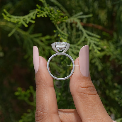 Moissanite solitaire ring with half-bezel setting on finger, side profile view