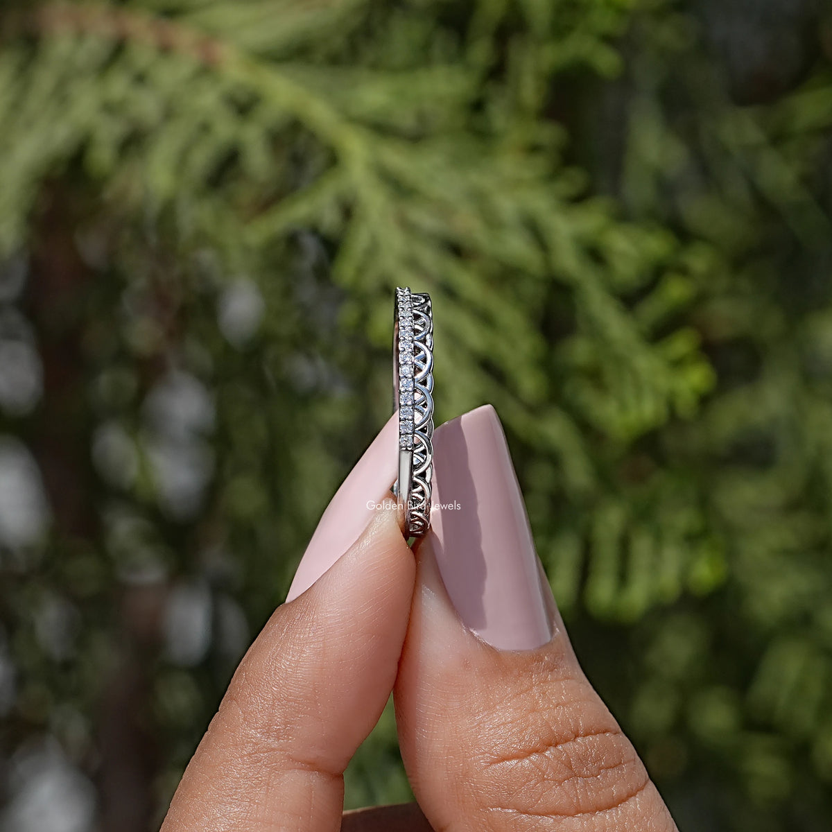 Moissanite stacking band in silver-tone metal, side view with pavé set round stones.