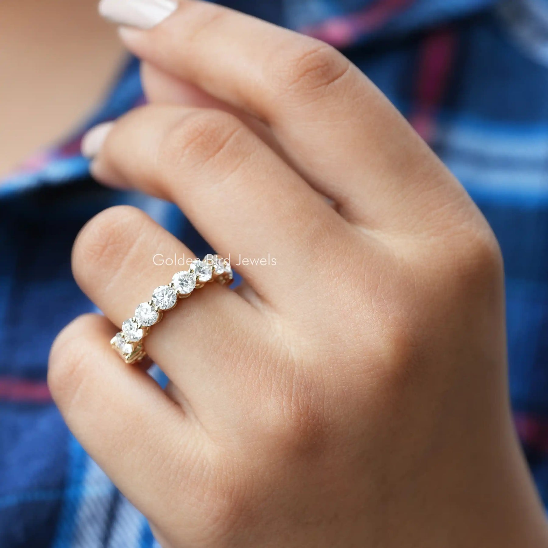 [in finger front view of half emerald and round cut moissanite band set in prongs]-[Golden Bird Jewels]