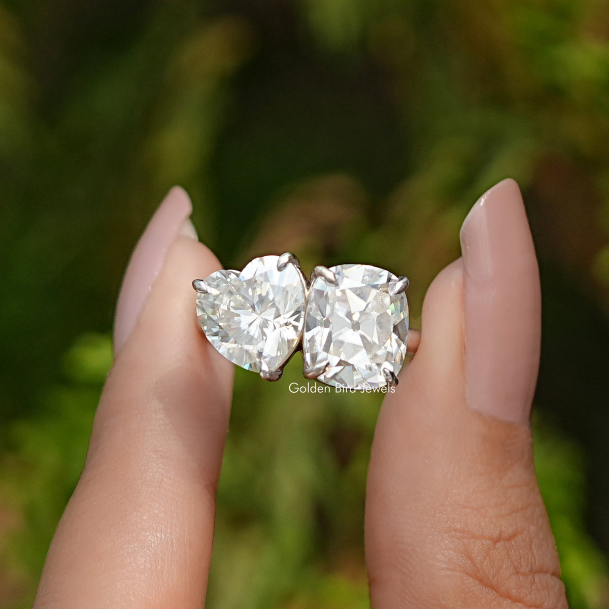 Front View of Heart and Cushion Cut Moissanite Toi Et Moi Ring In two Fingers