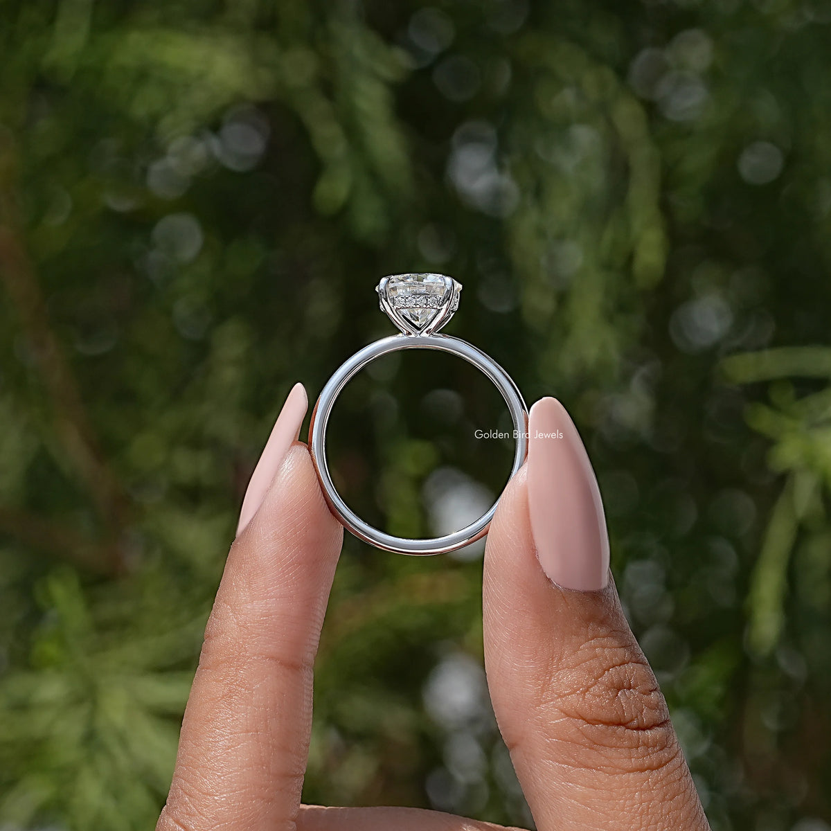 Round solitaire engagement ring showing side profile with prong-set round center stone