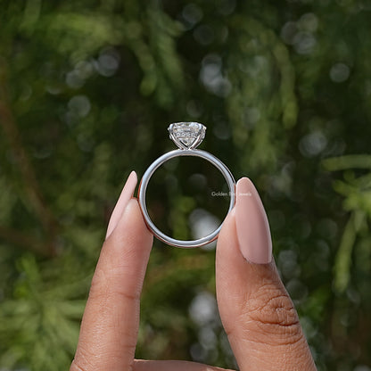 Round solitaire engagement ring showing side profile with prong-set round center stone