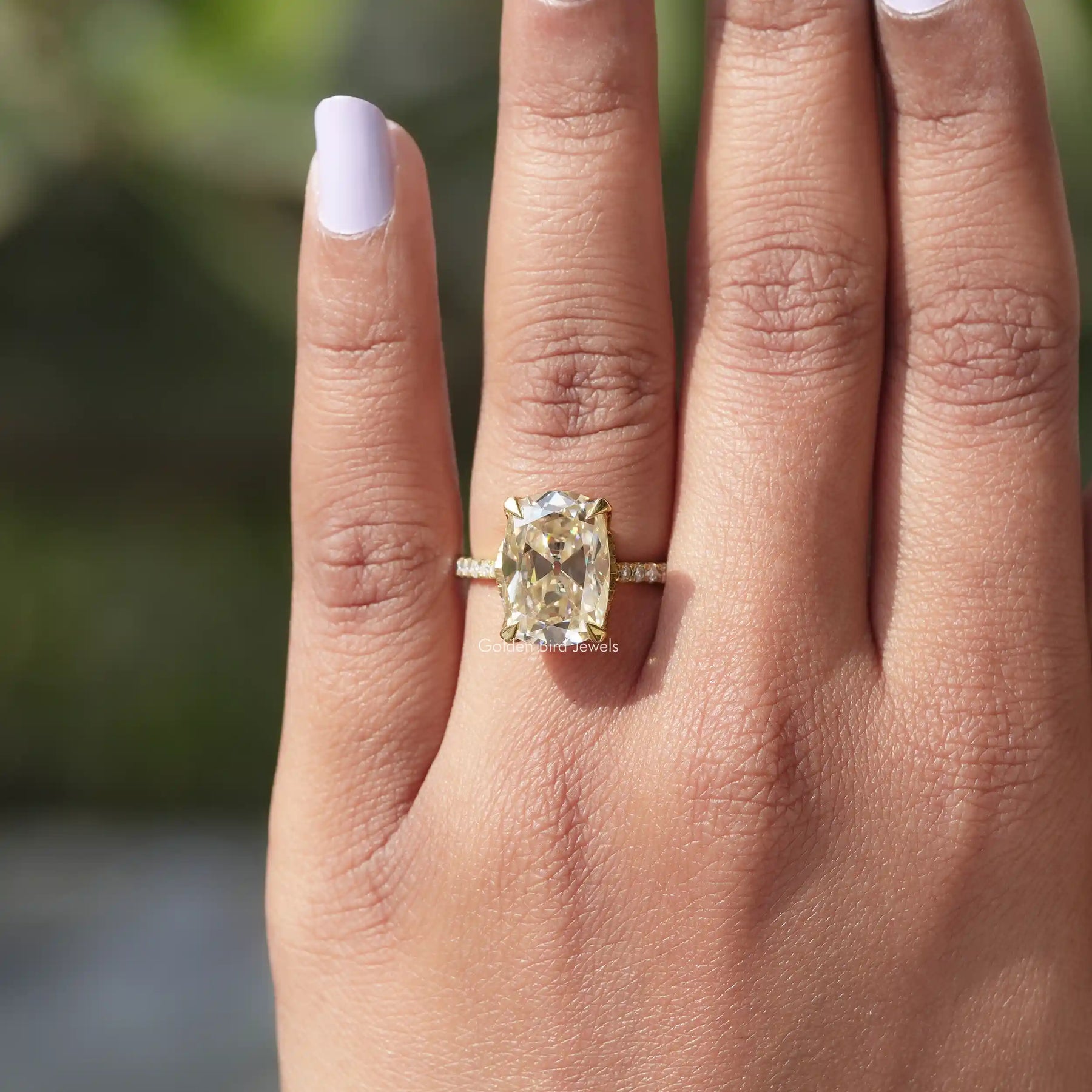 [In finger front view of hidden halo cushion cut moissanite ring]-[Golden Bird Jewels]