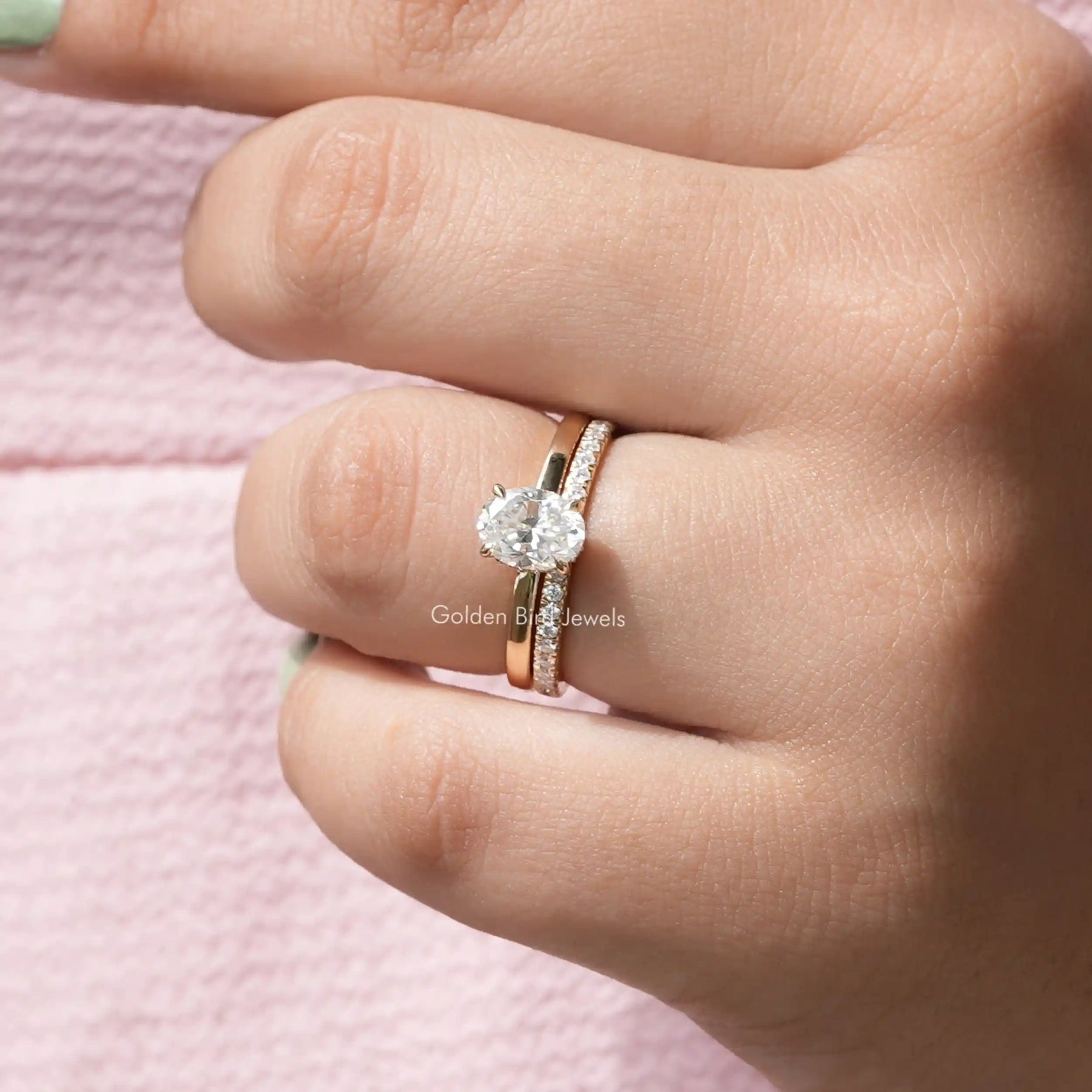 [In finger front view of oval cut moissanite ring made of four prongs in 14k yellow gold]-[Golden Bird Jewels]