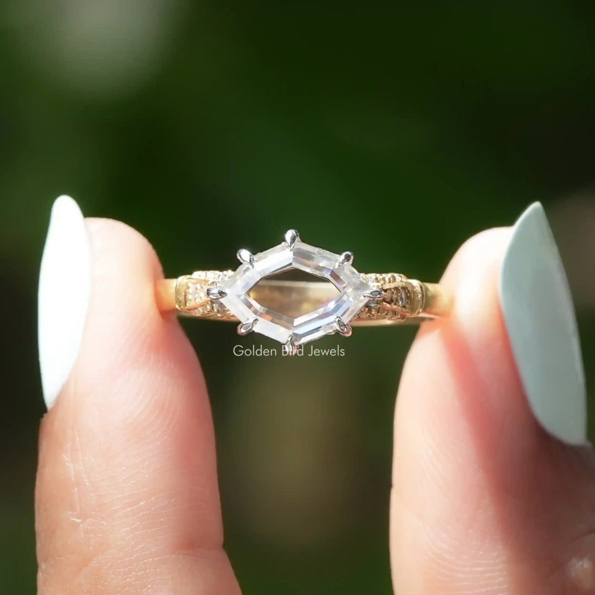 [In two finger front view of hidden halo step cut marquise moissanite ring]-[Golden Bird Jewels]