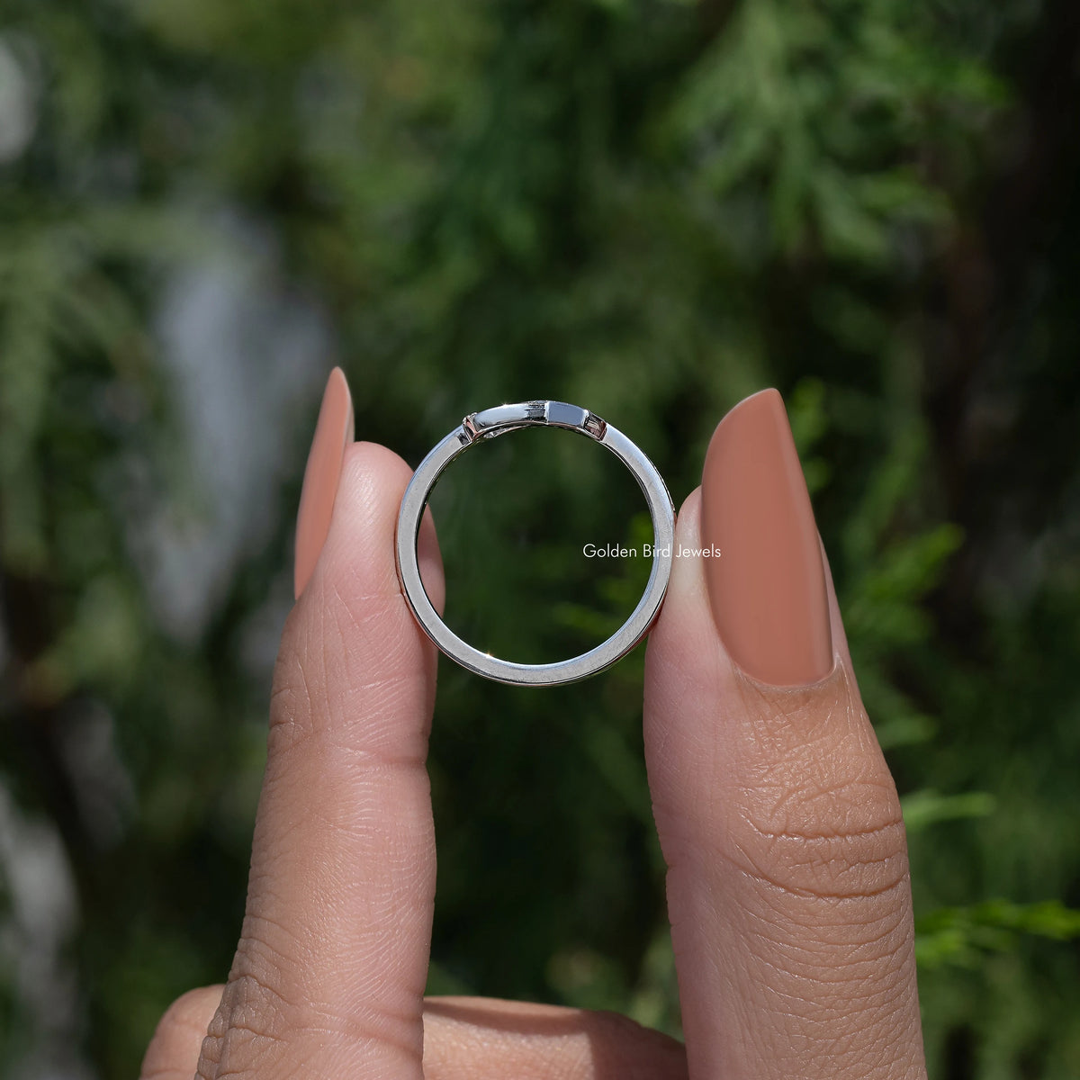 Silver hope ring with round-cut stones, viewed from the side