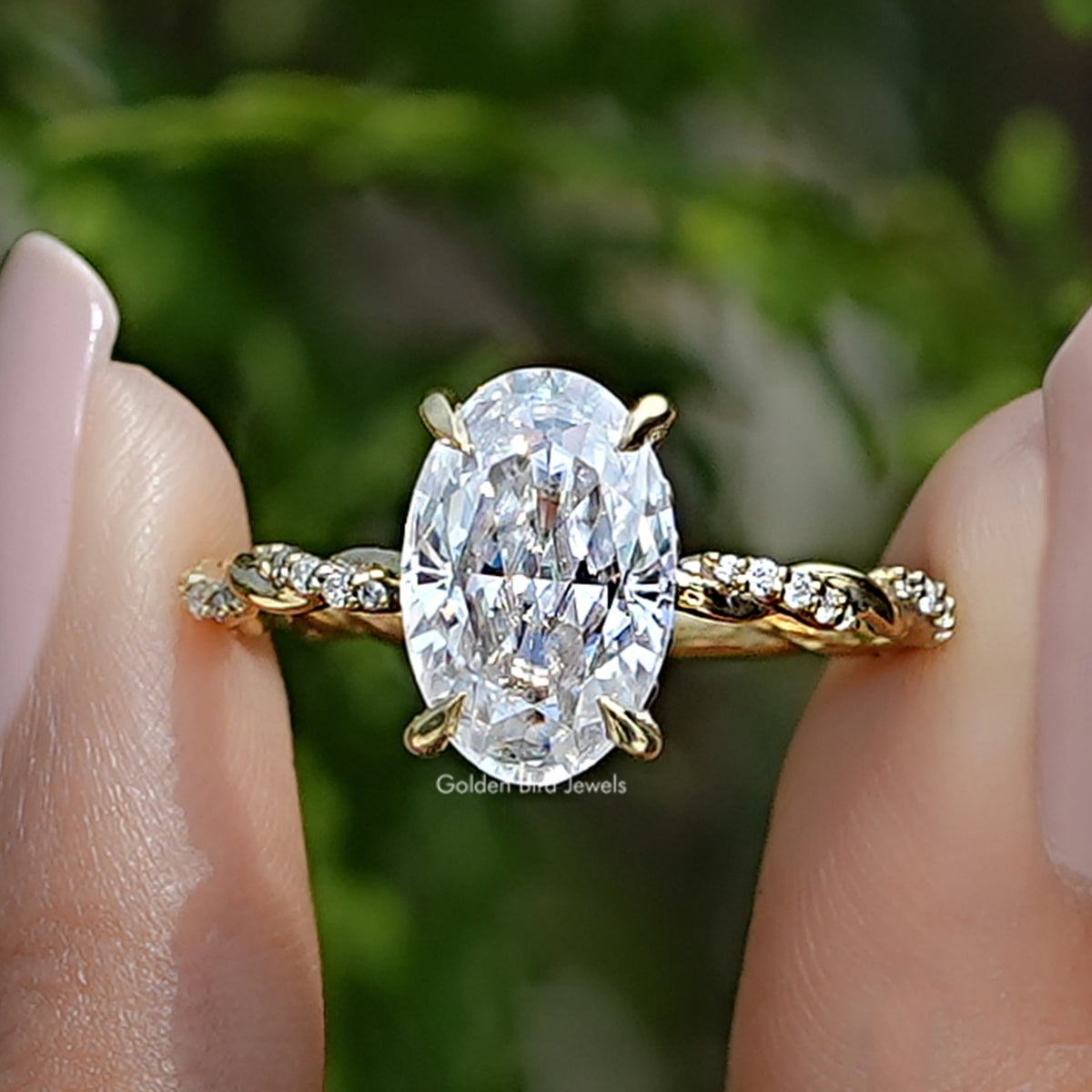 Front view of Crushed Ice Oval Moissanite Twist Shank Ring in two fingers 