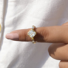 In finger front View of Diamond Asscher Cut Three Stone Ring In Yellow Gold