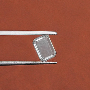 Tweezer hold the Portrait Emerald Cut Diamond