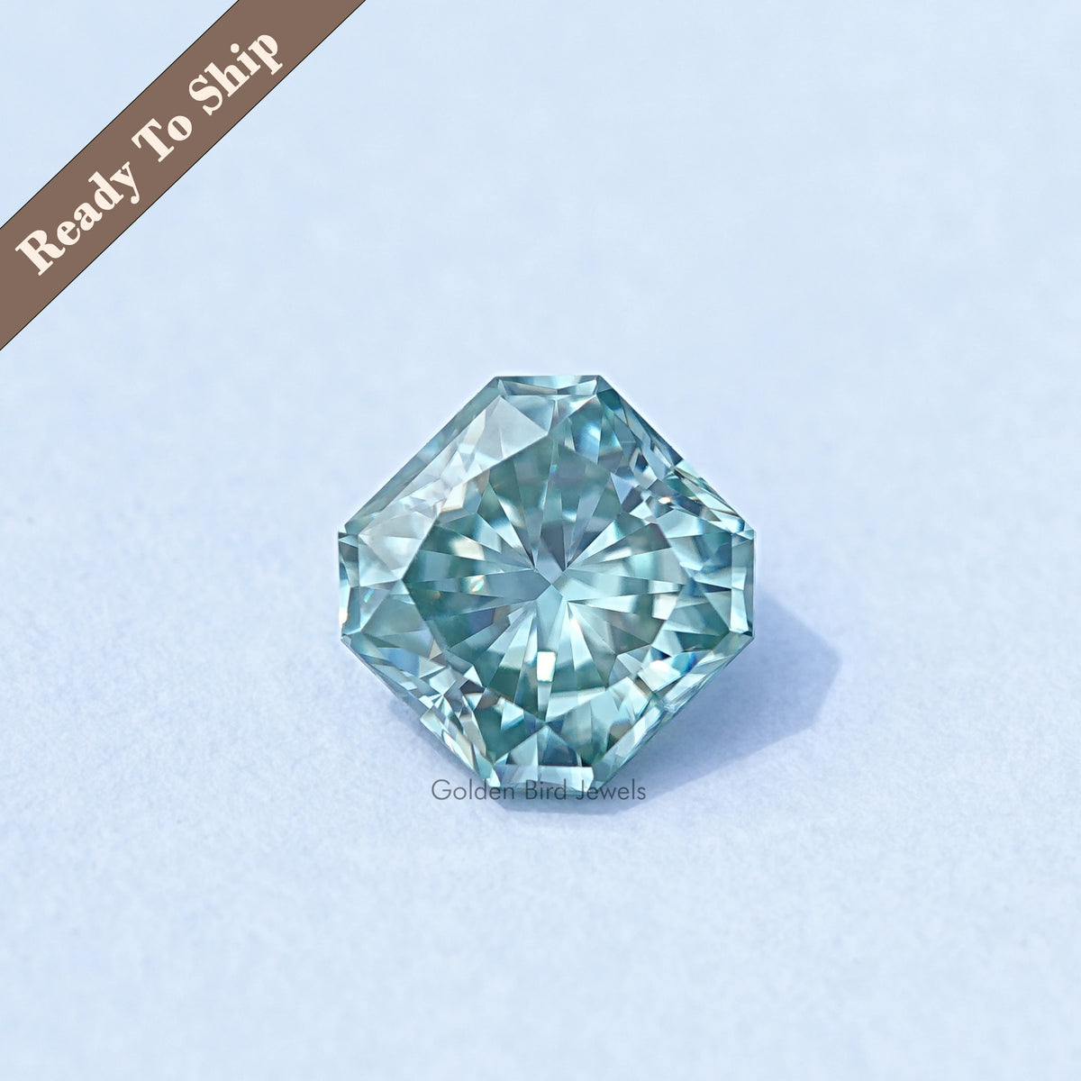 Green square radiant-cut moissanite gemstone with radiant faceted design