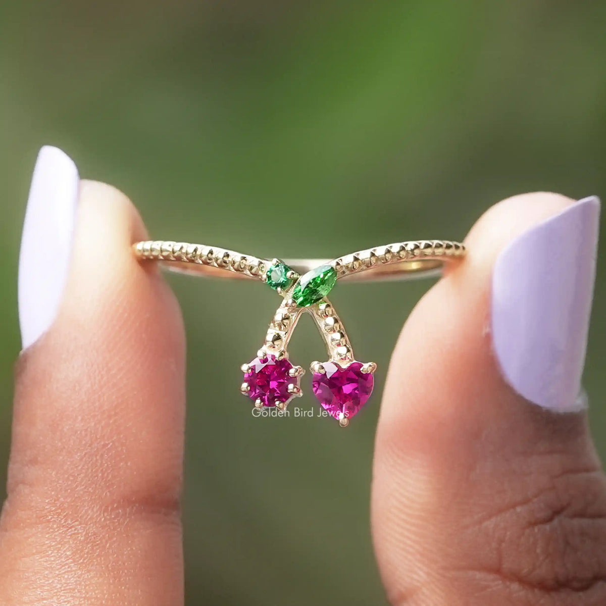 Two fingers holding the Marquise And Heart Cut Engagement Ring
