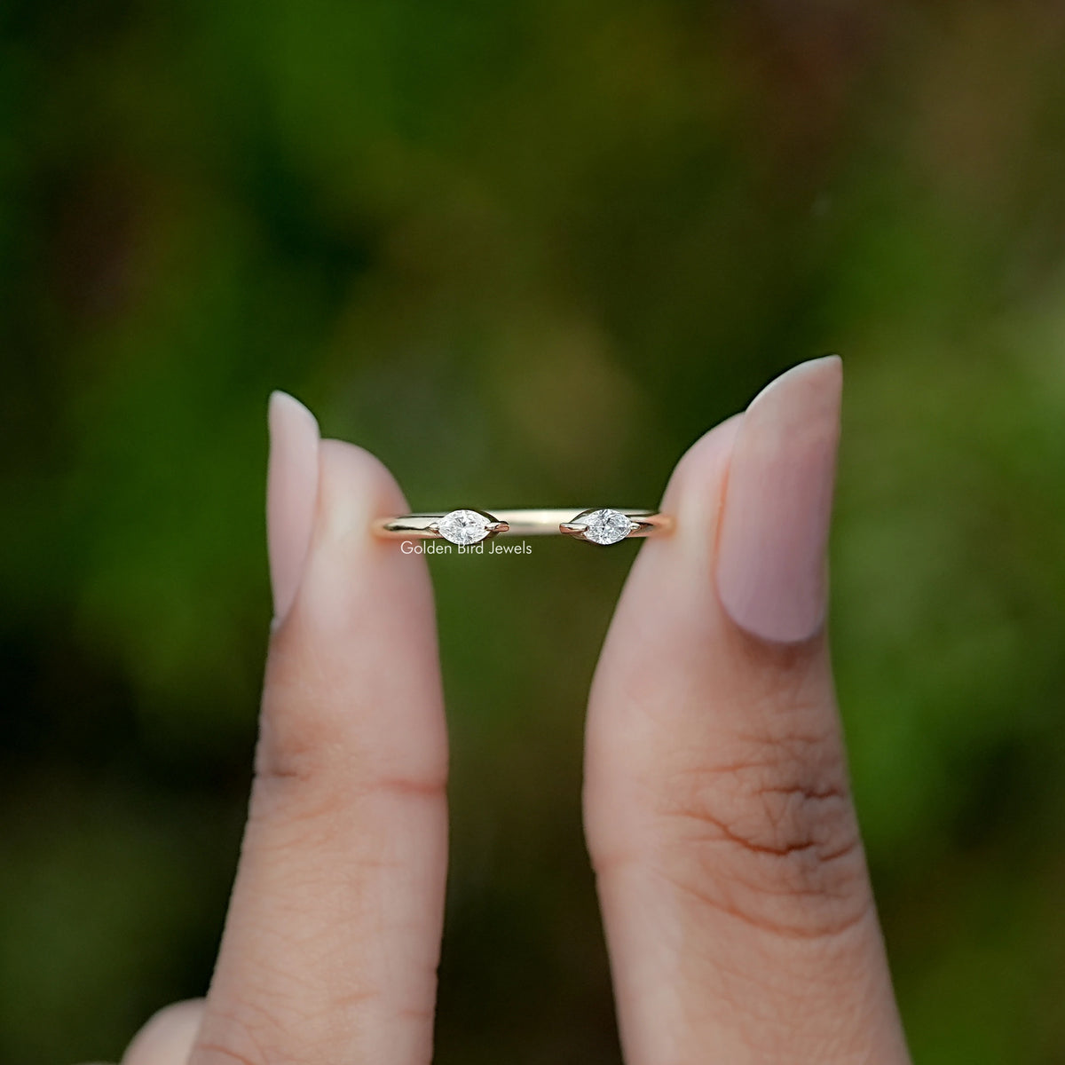 Front view of Lab Diamond Open Cuff Two Stone Ring ring holding in two fingers 
