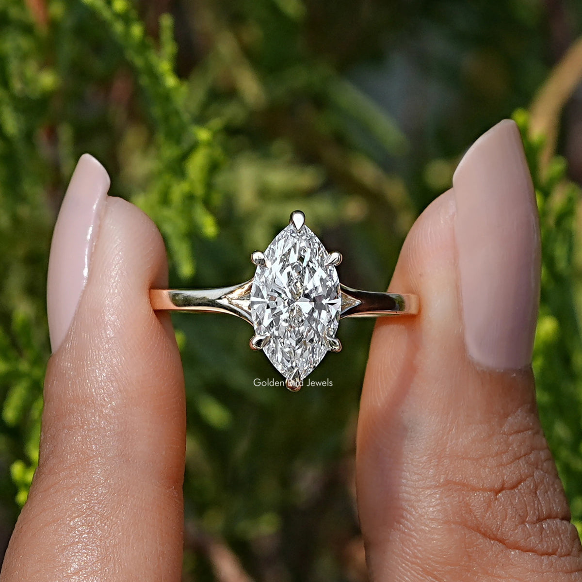 Front View of Marquise Cut Lab Grown Diamond Engagement Ring In two Fingers