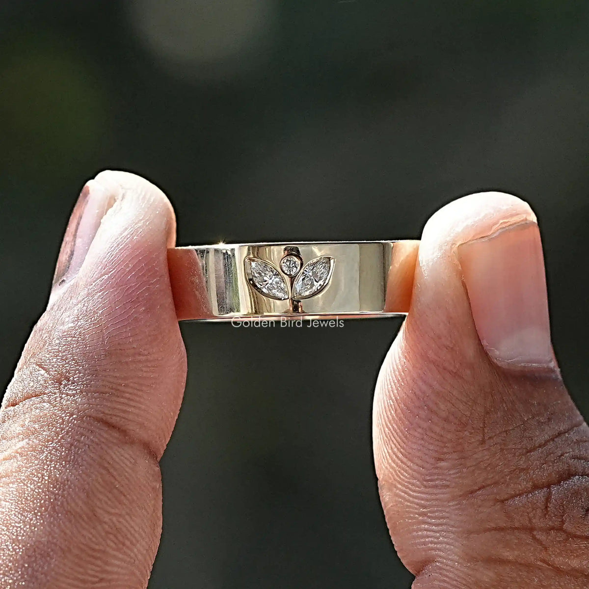 Two fingers holding the Marquise Cut Moissanite Flush Setting Ring