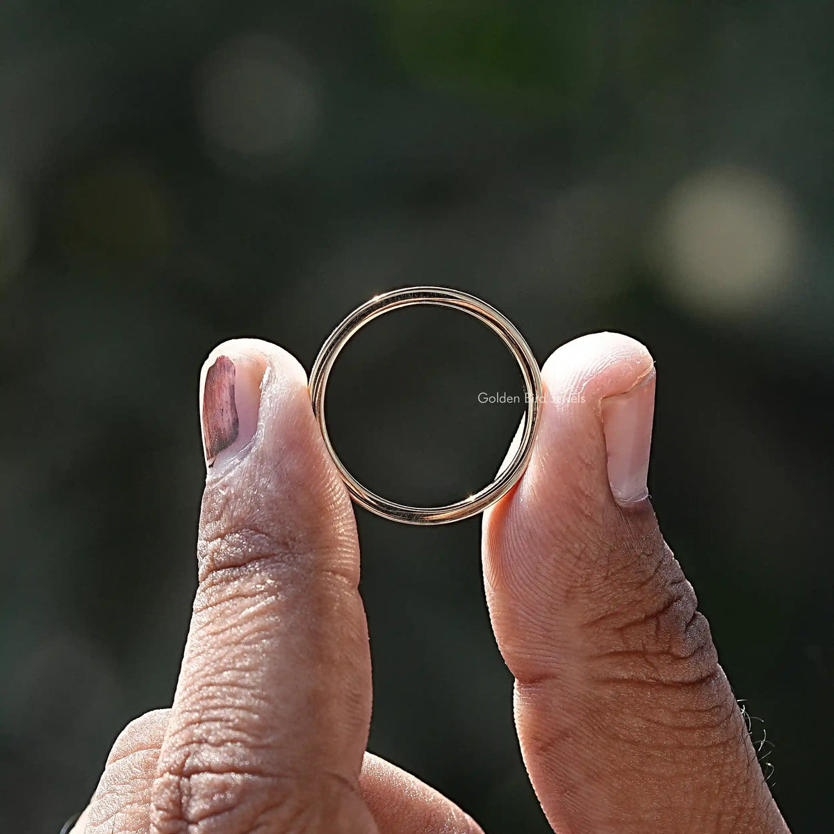 Back View of Moissanite Marquise Cut Flush Setting Ring In two fingers
