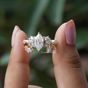 Two fingers holding the Dutch Marquise Cut Moissanite Ring 