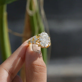 [In two finger front view of oval cut moissanite ring]-[Golden Bird Jewels]
