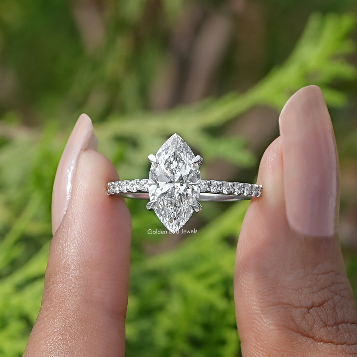 Front View of Marquise Cut Diamond Solitaire Ring In two fingers