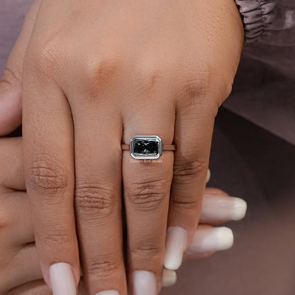 Square gray moissanite solitaire ring with silver band on hand, four-prong top