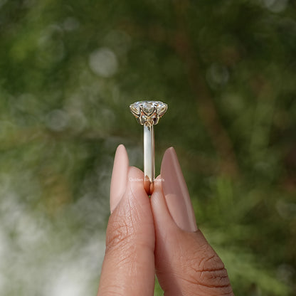 Moissanite solitaire ring shown from side, prong-set round center stone