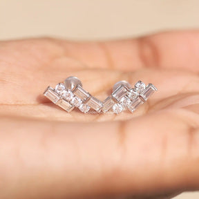 In Hand View Of baguette and round cut moissanite stud Earring