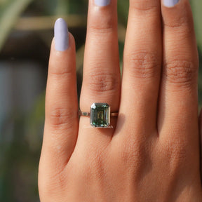 Close-Up View Of Green Emerald Moissanite Ring In a finger