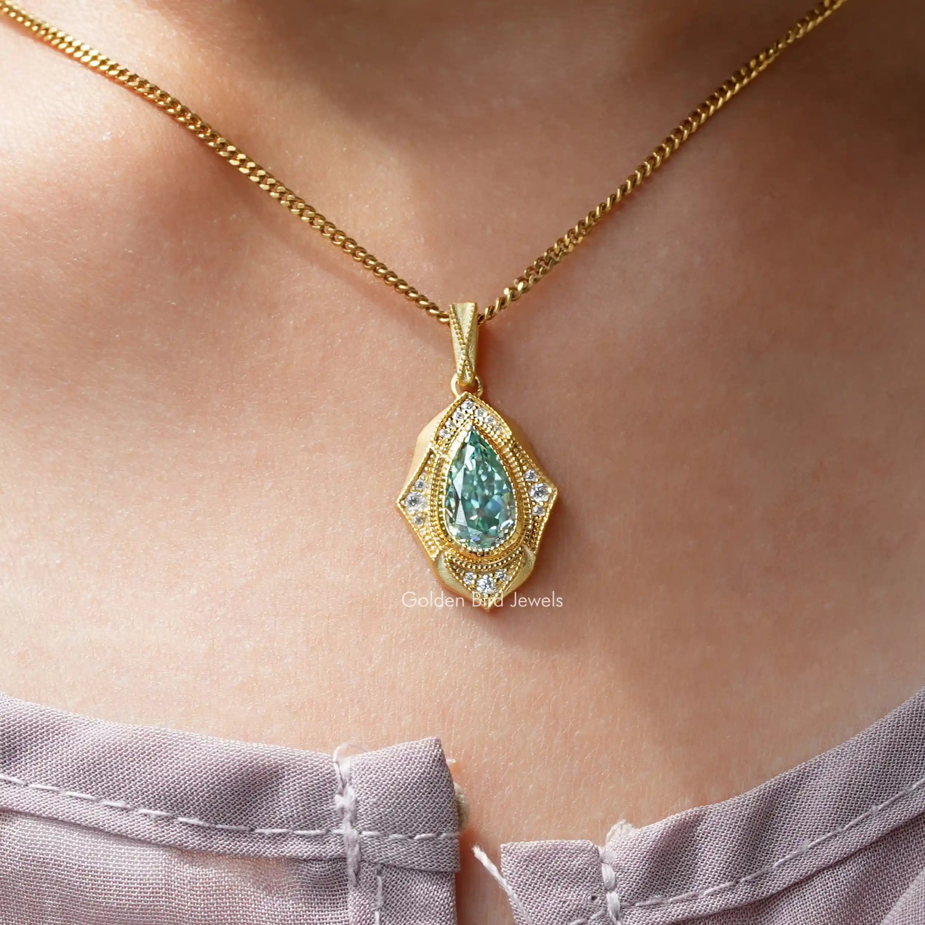 [In neck front view of blue pear cut moissanite pendant made of vs clarity]-[Golden Bird Jewels]