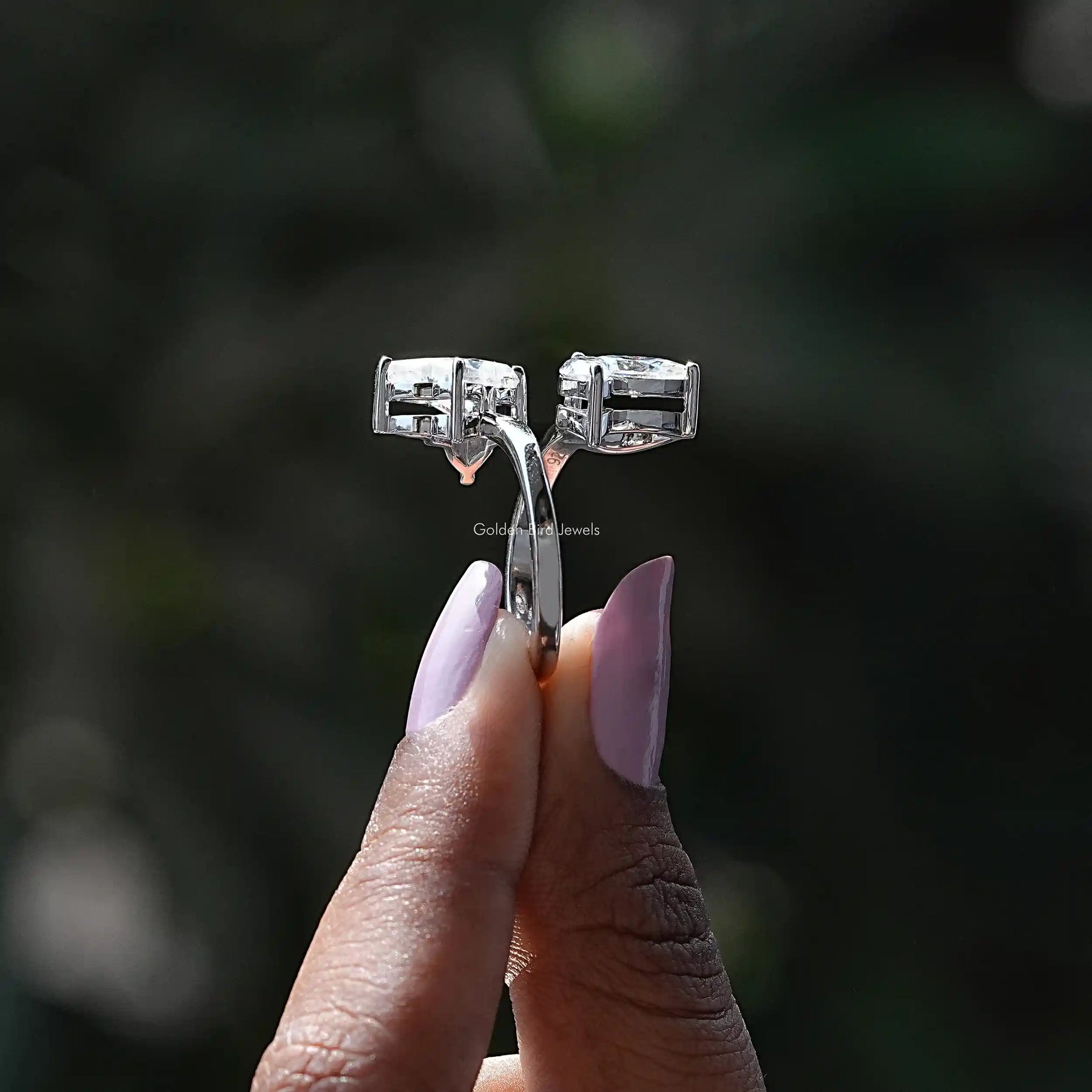 Side View of Butterfly And Marquise Cut Moissanite Bypass Ring In two fingers