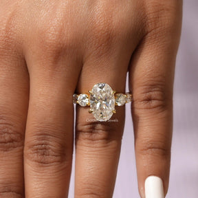 [In finger front view of oval and round cut moissanite ring]-[Golden Bird Jewels]