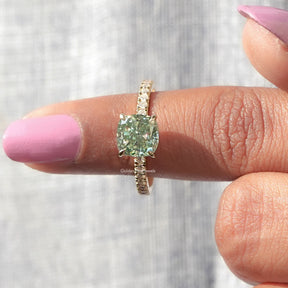 In finger front View of Round And Cushion Cut Moissanite Ring In Yellow Gold