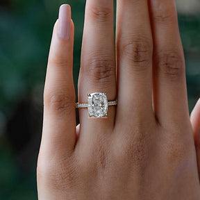 In finger front view of halo cushion moissanite engagement ring 