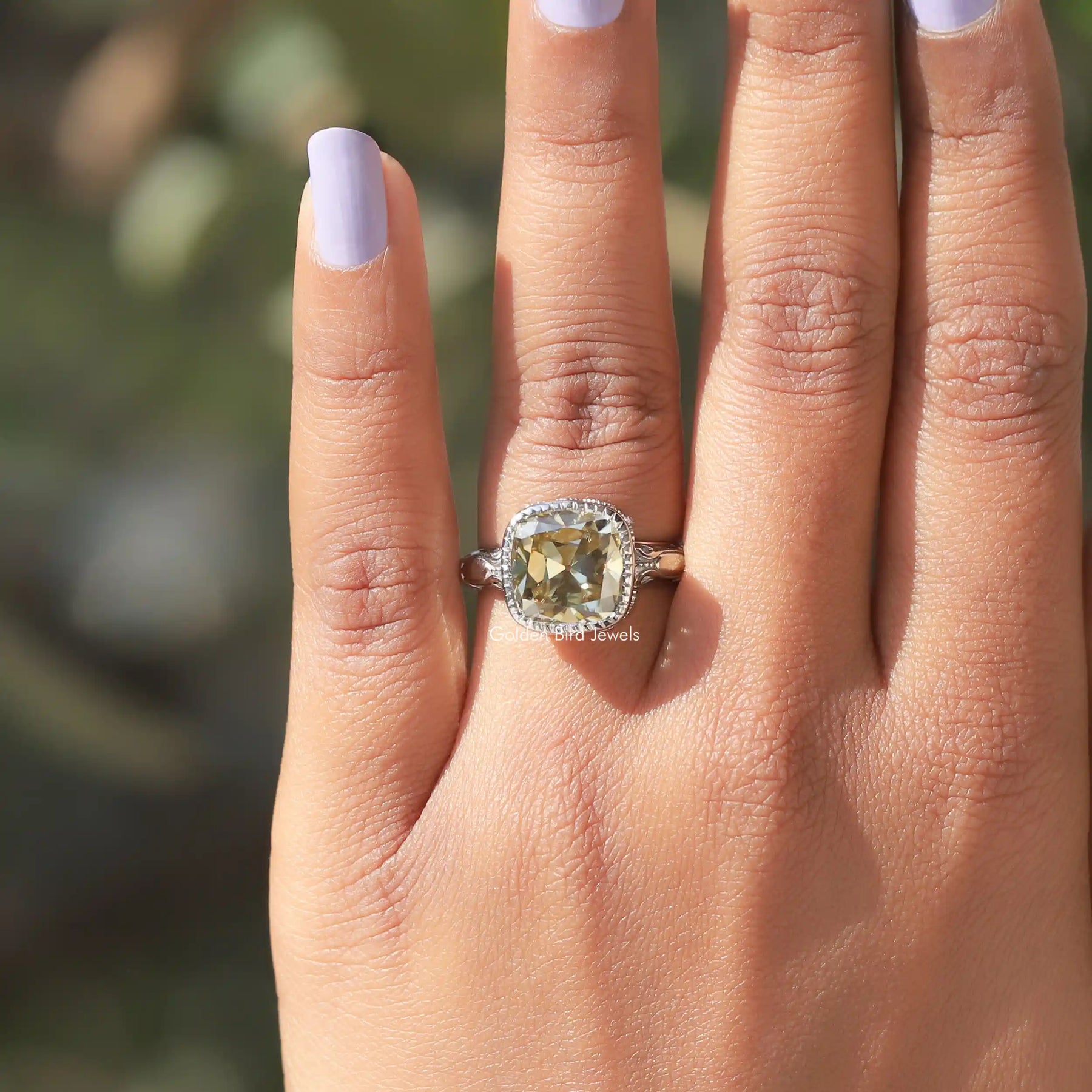 [In finger front view of cushion cut milgrain engagement ring crafted with bezel setting]-[Golden Bird Jewels]