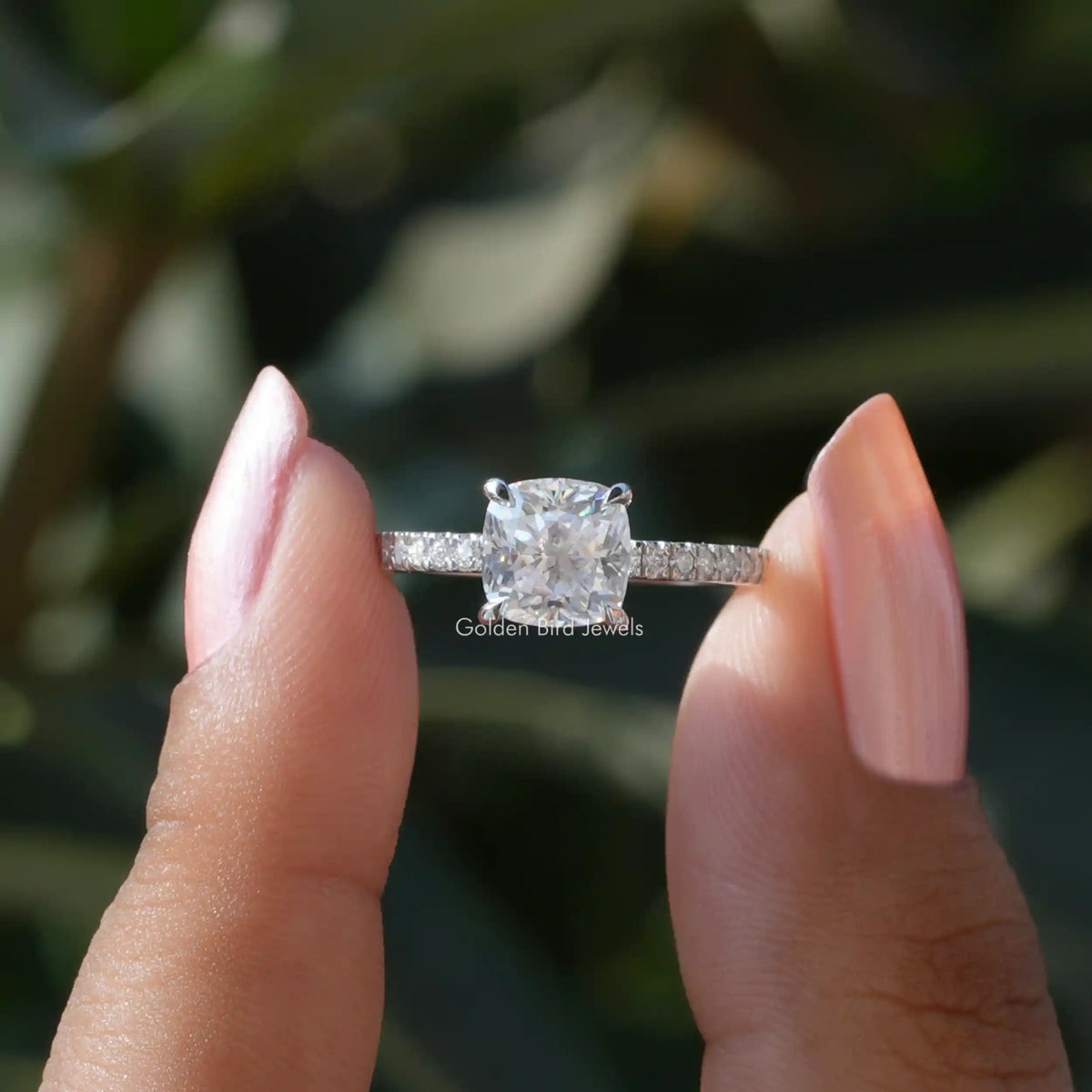 Front View of Cushion Cut Solitaire Accent Engagement Ring In two Fingers
