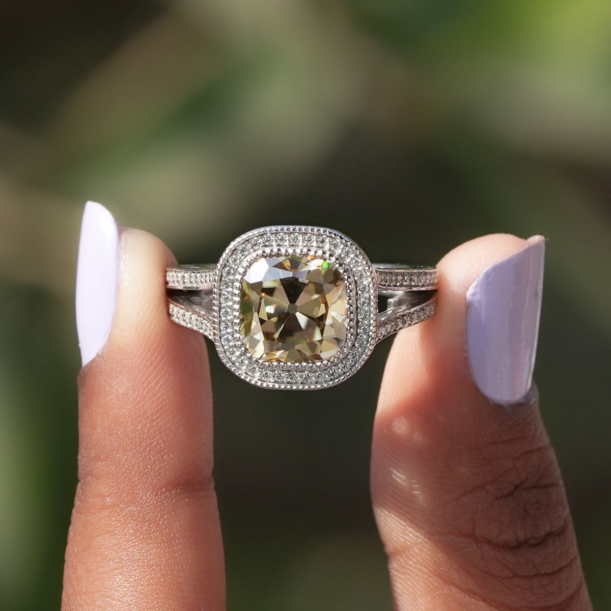 [In two finger front view of old mine cushion cut moissanite halo ring]-[Golden Bird Jewels]