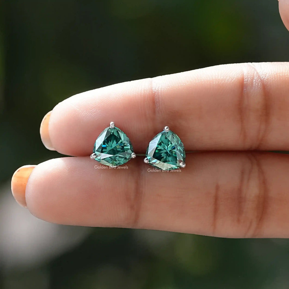 In two-finger view of trillion cut moissanite ring 