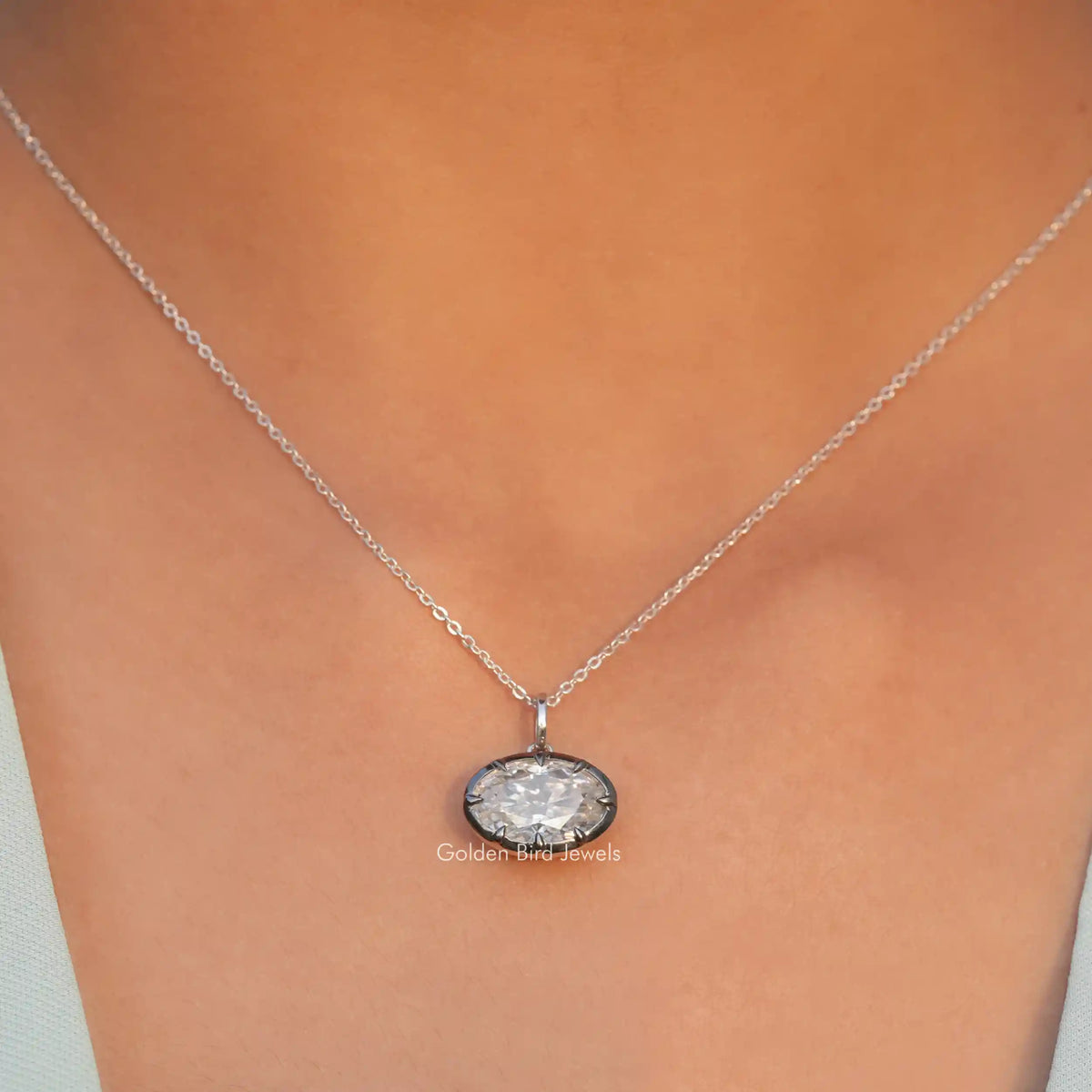 View of ice oval cut moissanite solitaire pendant 