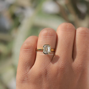 Close-Up View of Moissanite Emerald Cut Bezel Set Solitaire Ring In White Gold