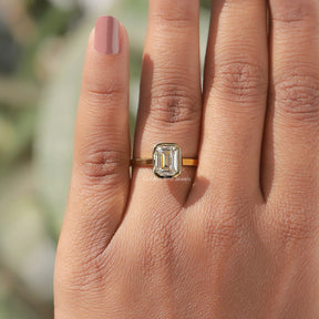 Detailed View Of Emerald Cut Bezel Set Engagement Ring In Yellow Gold