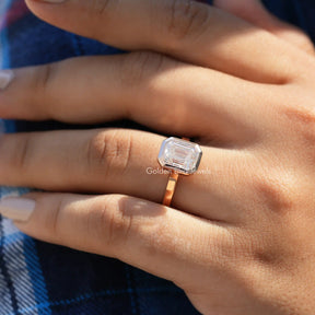[In finger front view of emerald cut moissanite ring made with rose gold]-[Golden Bird Jewels]