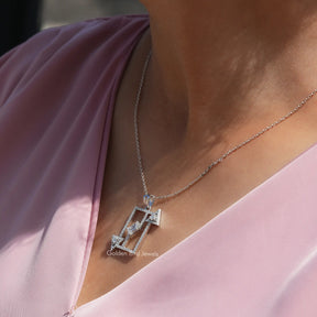 Side view of emerald cut pendant In white Gold