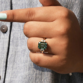 View of Green Emerald Cut Moissanite Engagement Ring In Yellow Gold