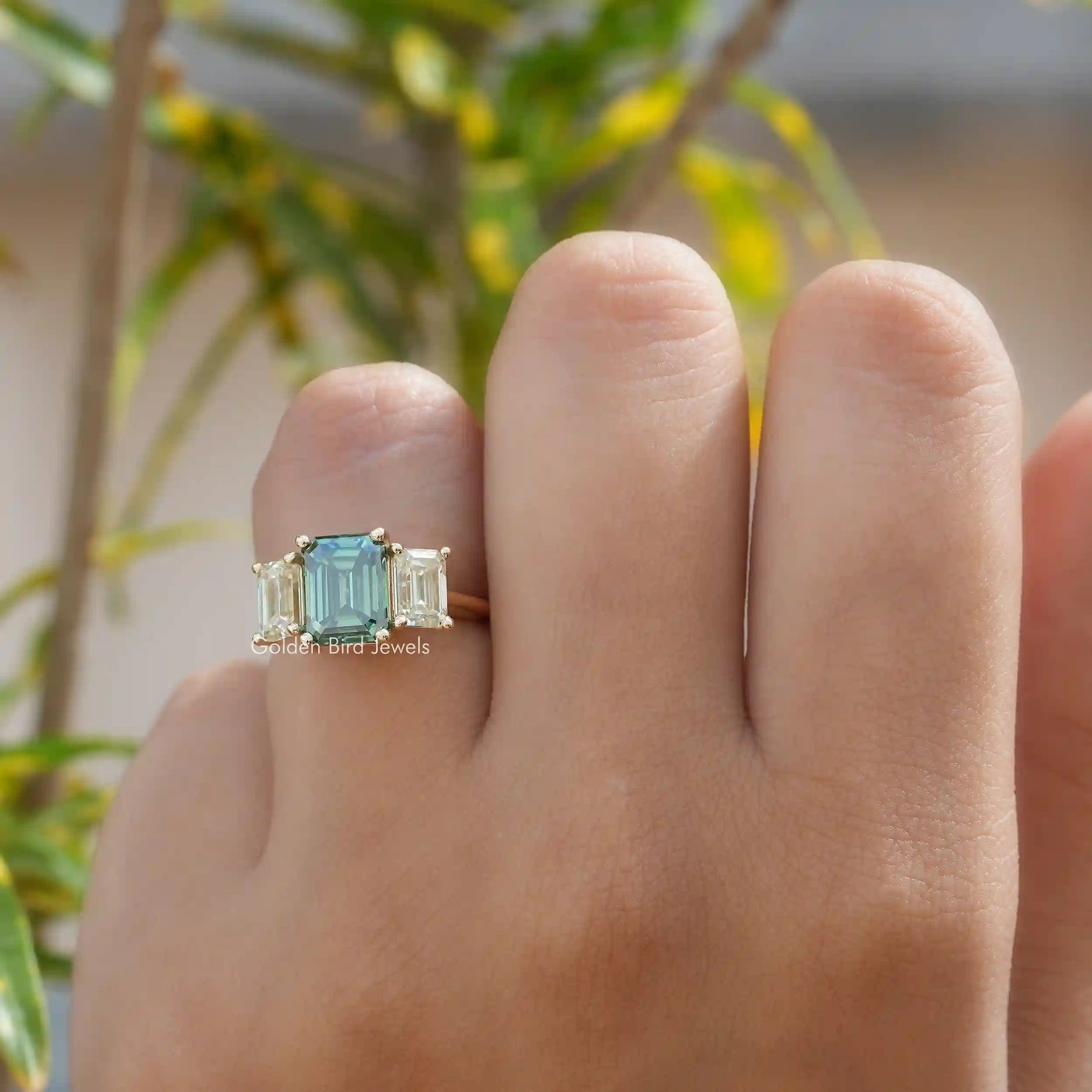 [In finger front view of moissanite emerald cut 3 stone ring]-[Golden Bird Jewels]