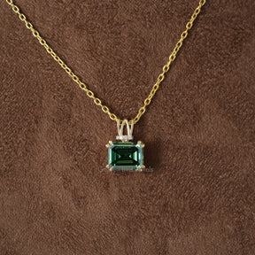 [Front view of green emerald cut moissanite pendant in 14k yellow gold]-[Golden Bird Jewels]