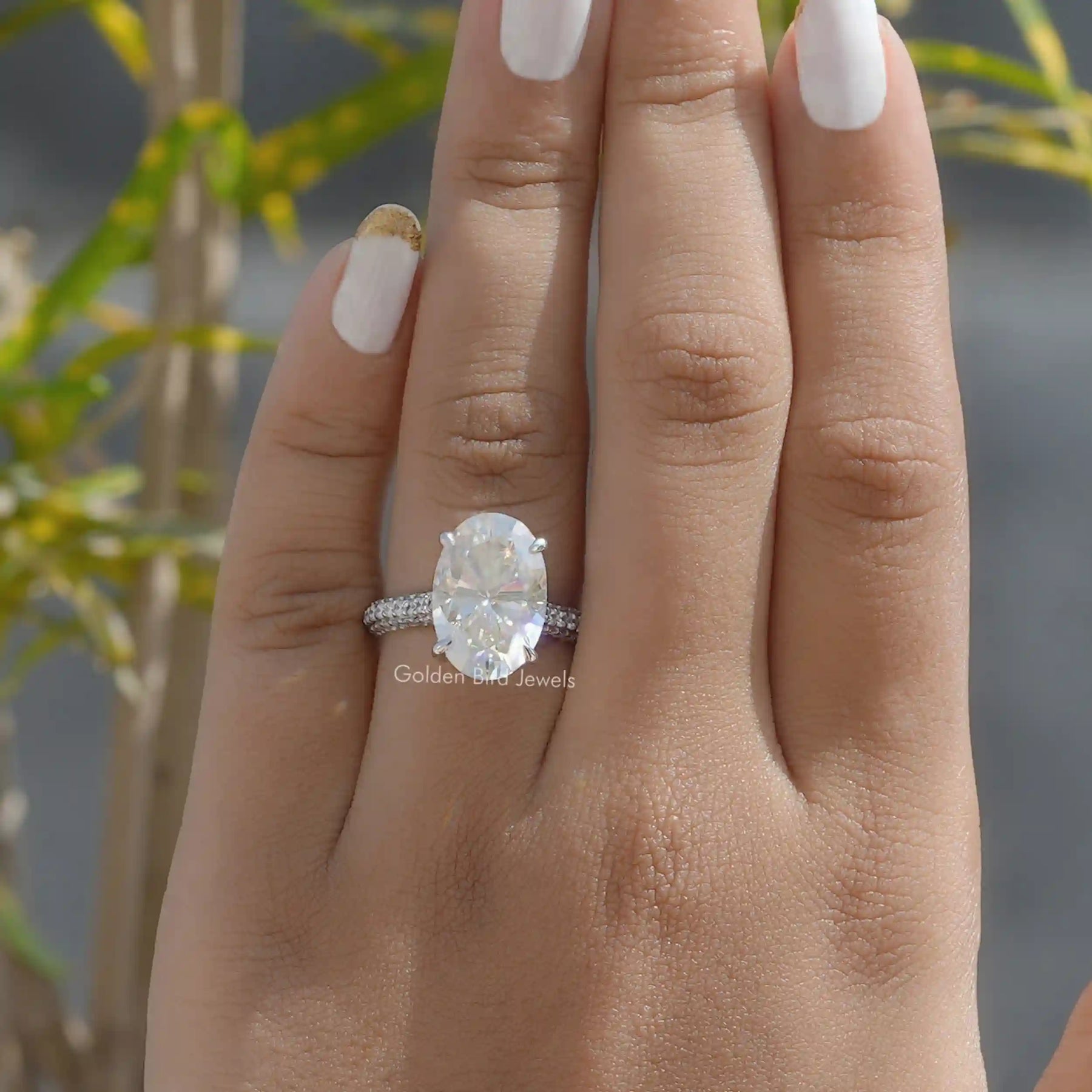 [In Finger a Moissanite Engagement Ring Made Of Oval Cut Stone]-[Golden Bird Jewels]