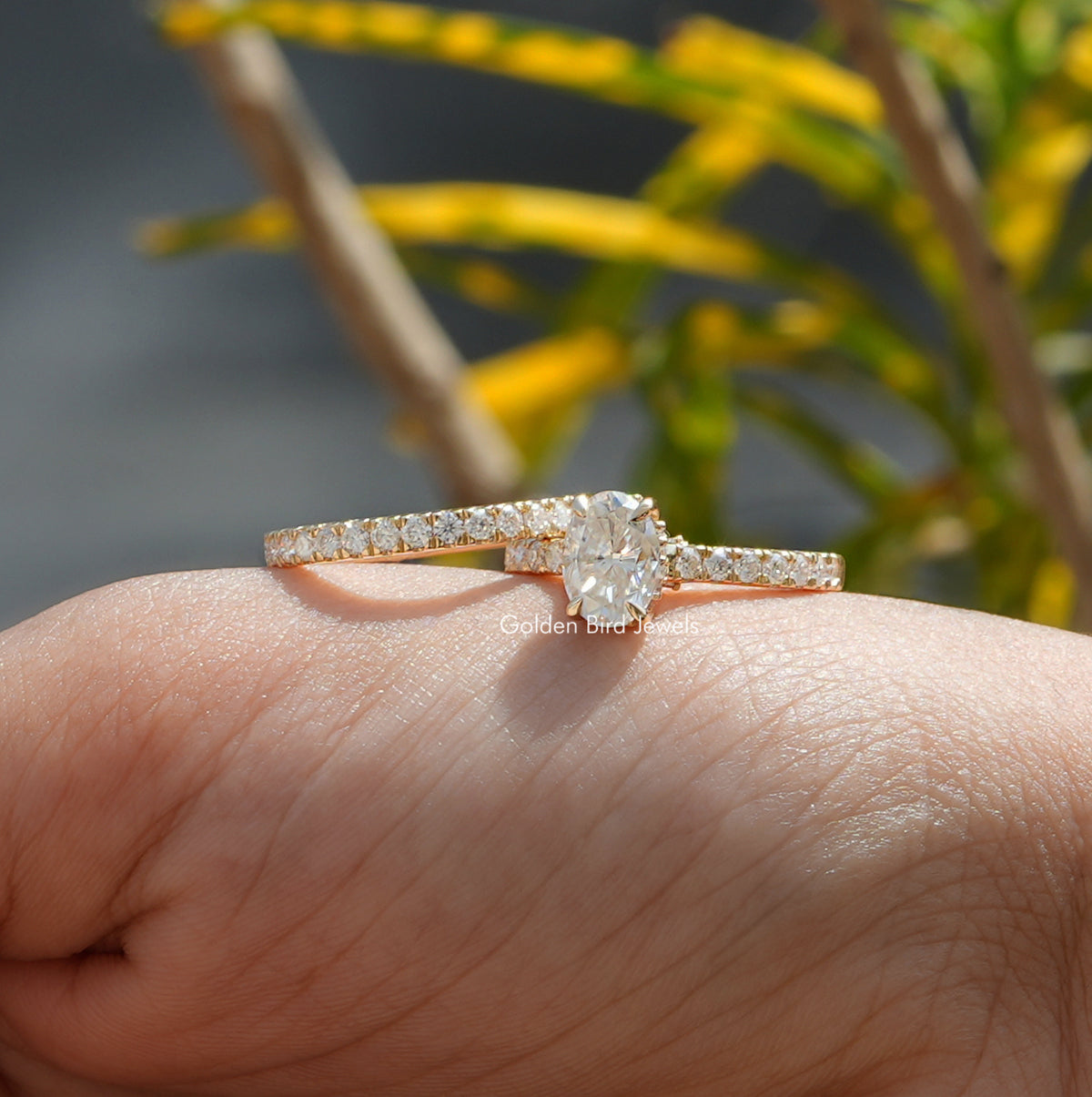 Oval cut hidden halo moissanite ring with matching eternity 
band 